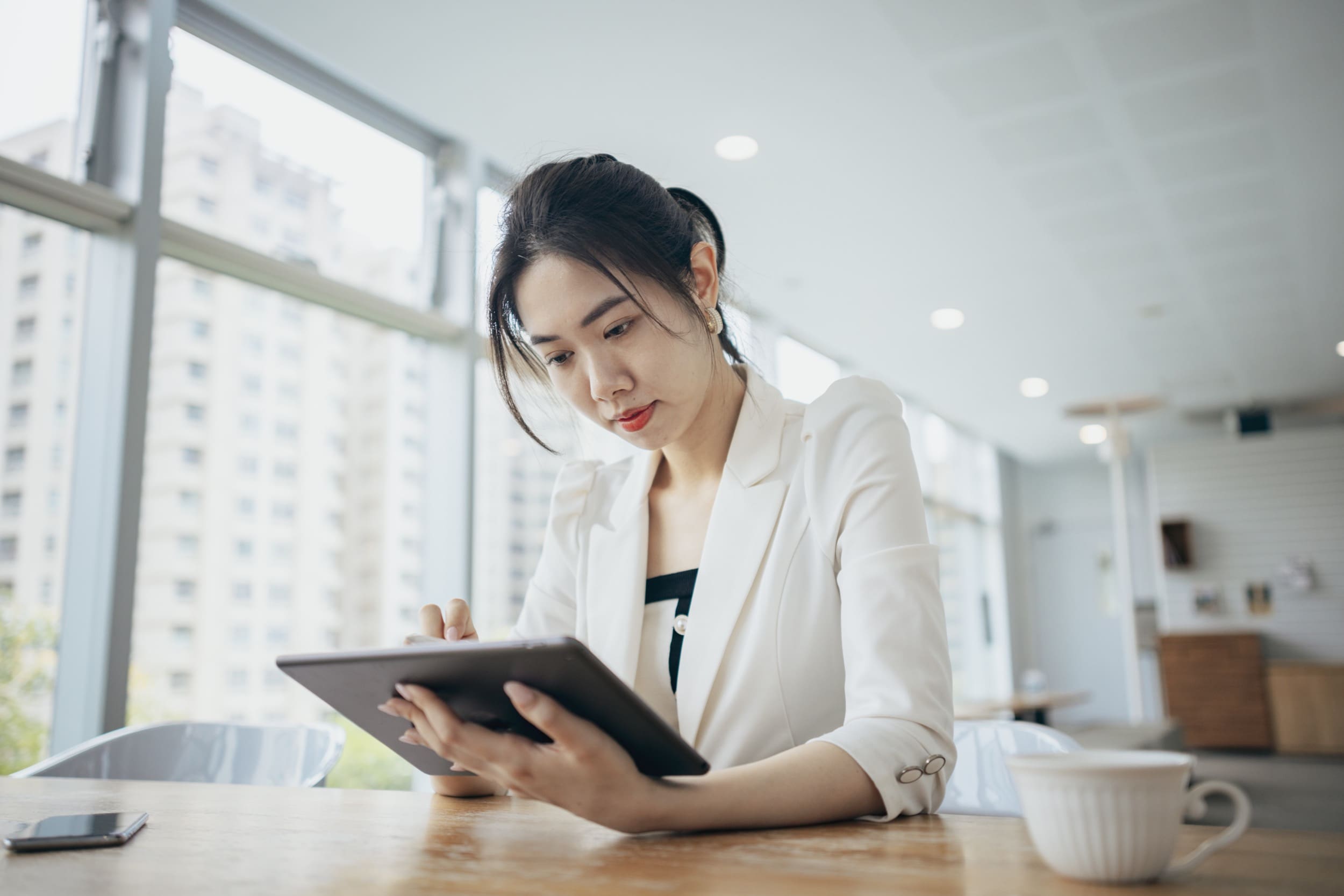 Person engaging with software on a tablet device.