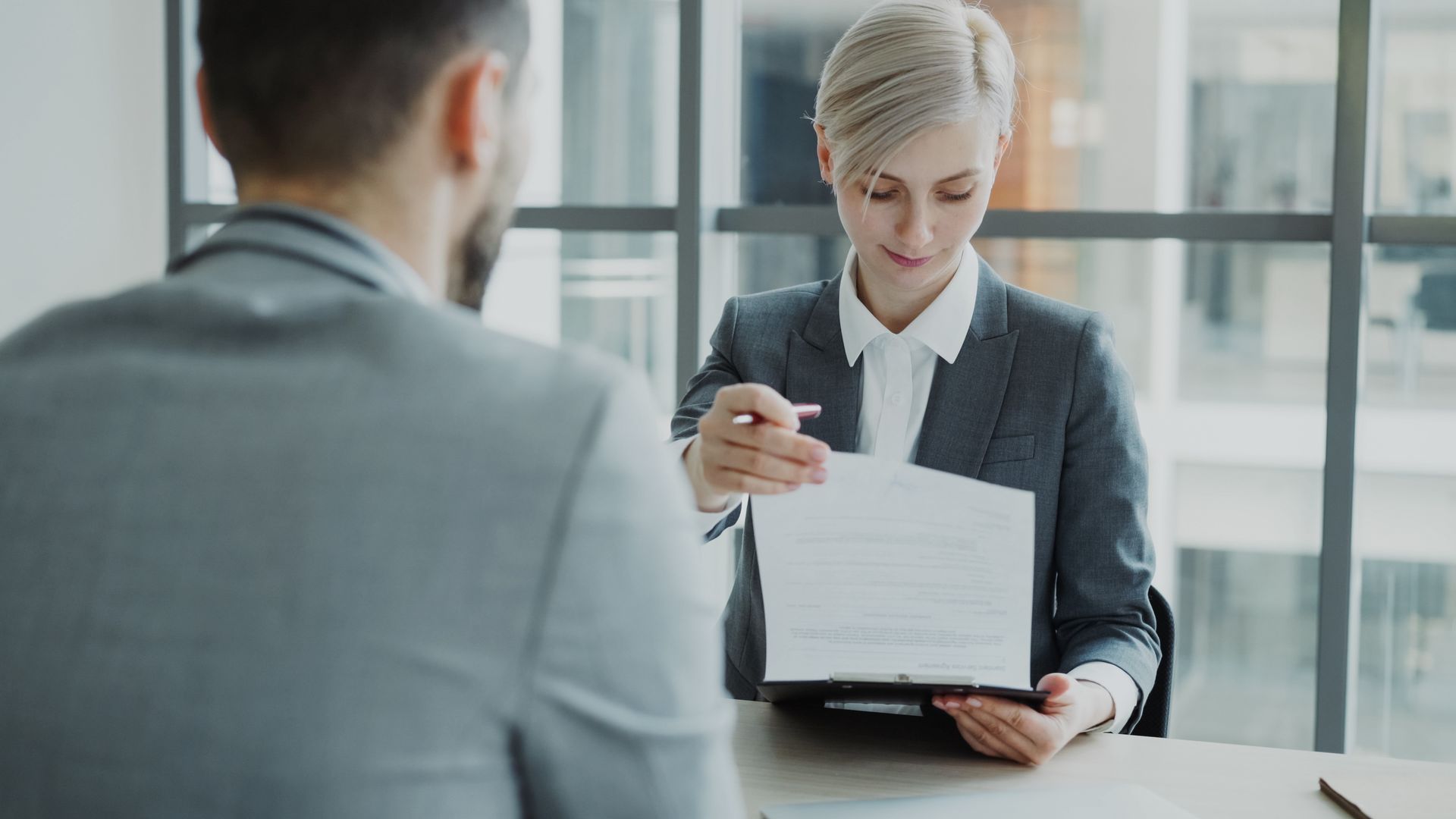 HR professional reviewing a document during a workplace investigation interview